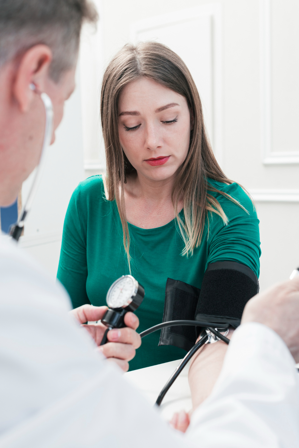 female employee getting blood pressure checked health and wellness coach mobile medical corporation