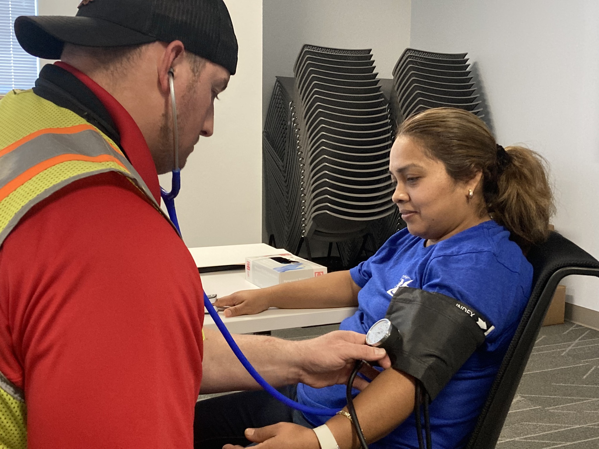 female employee getting blood pressure check mobmed